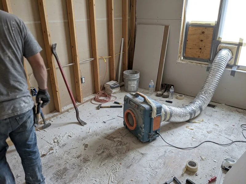 HEPA air scrubber with ducting running in a work area