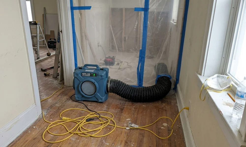 HEPA air scrubber with ducting running in a work area